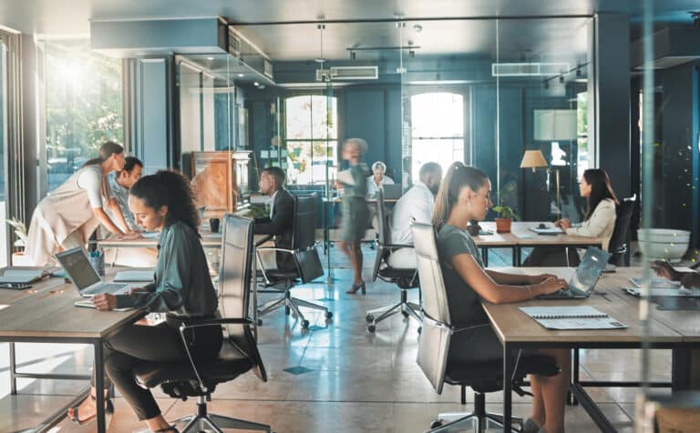 Corporate business people working in busy marketing office space, planning strategy in books and reading email on laptop at work